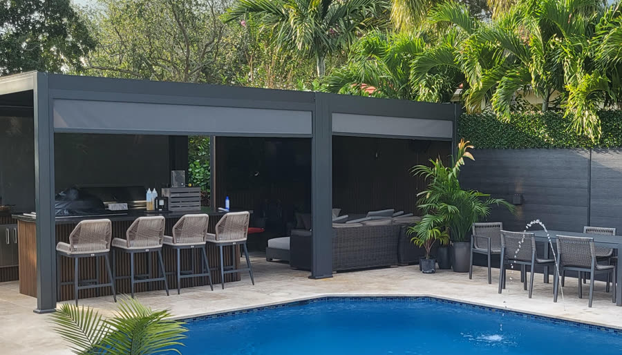Louvered pergola over a poolside bar and seating area